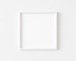 © Washdog - White square photo frame on white wall. 3d illustration.