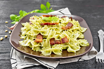 Wall Mural - Farfalle with pesto and bacon on wooden board