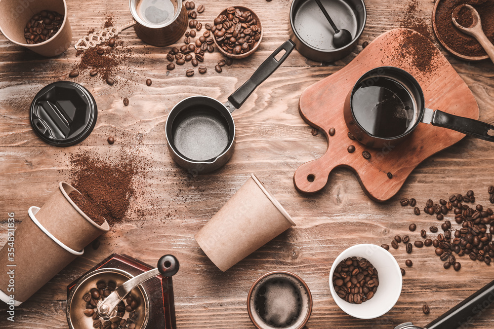 Composition with coffee beans and powder on wooden background