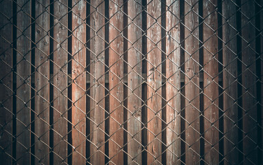 Wooden fence and metal mesh chain link, texture