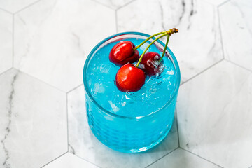 Wall Mural - Blue Lagoon Cocktail with Cherries and Crushed Ice.