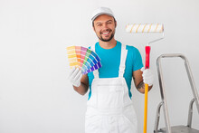 Cheerful Painter With Palette And Paint Roller