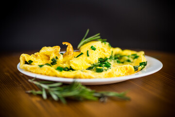 Sticker - hot fried omelet with chopped green onions in a plate