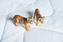 Beautiful Miniature White And Brown Tigers Made Of Rubber Or Plastic. Perfect Toys For Children To Play With. Blurred Background. Top View