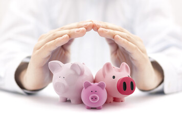 Canvas Print - Group of piggy banks covered by hands