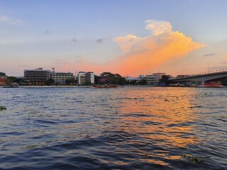 Sunset at the Chaopraya river in Thailand with blue and orange sky