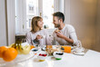 © Davide Angelini - Happy couple having healthy breakfast together at home