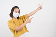 © Chatsiri - Young happy Asian woman wearing hygienic mask to prevent infection corona virus Air pollution pm2.5 she wearing a yellow sweater shoot in shot isolated on white background