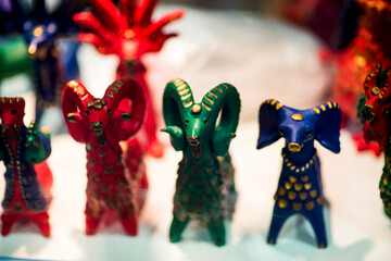 Beautiful vintage colourful wooden satanic dolls at market. Baphomet dolls is folks cultural symbol of Satanic cult. With selective focus on one doll.