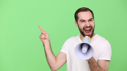 Wall Mural - Bearded fun young guy 20s in white t-shirt hold in hand scream in megaphone announces discounts sale Hurry up isolated on green chroma key background studio. People sincere emotions lifestyle concept