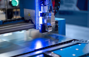 The CNC laser cut machine while cutting the sheet metal with the sparking light.The hi-precision sheet cutting process by laser cut