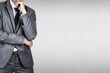 © Muhammadsainudin - Businessman in suit on gray background.The boss have vision and leadership for strategy in business to success in market mechanism concept.