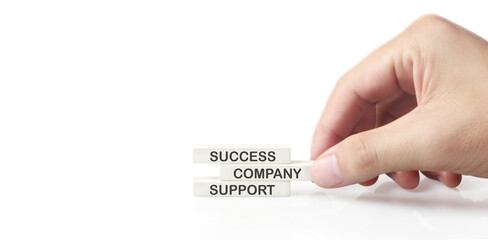 Cube with words success, company, support, quali ty, mission, business, in hand