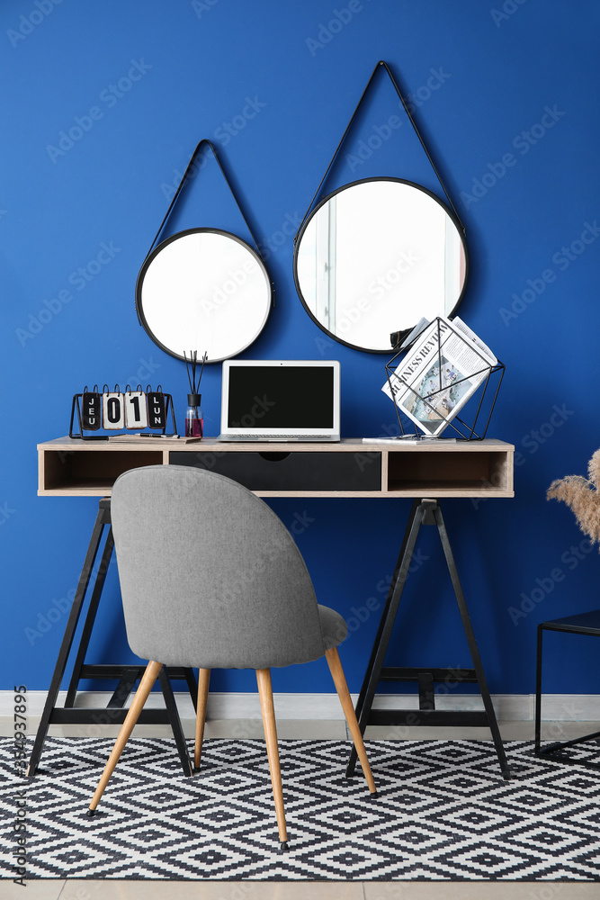 Interior of modern room with workplace and mirrors