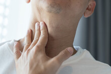 Sore Throat Healthcare Concept. Hand Of Man Touch His Neck With Red Spot As Sickness With Pharynx Inflammation Disease