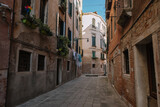 Fototapeta Na drzwi - Deserted street of Venice and only linen is dried on a rope, Italy.