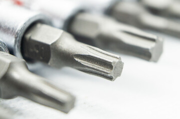 Close-up set of steel interchangeable screwdriver bits. Macro photography