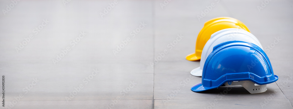 Banner copy space Construction hard hat safety tool equipment for workers construction site engineering protection head. Many hard hat helmet on row with copy space. Engineering Construction Concept - obrazy, fototapety, plakaty 