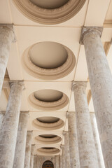 galleria of huge colums in summer day. fragment of soviet architecture park entenance