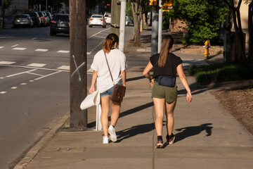 2 young female activists walk towards a protest in Raleigh