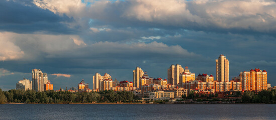 Wall Mural - View to the waterfront of Obolon district  in the Kyiv at sunset with colourful clouds. 