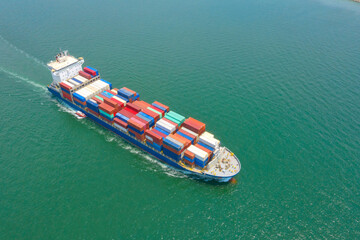 Container ship in export and import business and logistics. Shipping cargo to harbor by crane. Water transport International. Aerial view and top view.