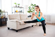 © Admiral - Workout routine at home. Attractive fitness woman doing lunges exercise is using home equipment in the living room. Copy space
