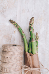 Wall Mural - fresh bunch of organic green asparagus spears on wooden table