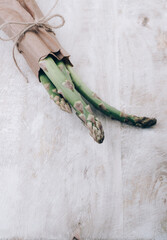 Wall Mural - fresh bunch of organic green asparagus spears on wooden table