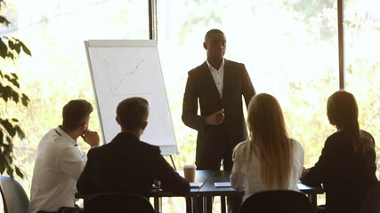 Poster - African coach stands near flip chart showing sales growth shown on raising graphic during corporate training, finish presentation with positive forecast and participants applauses express gratitude.