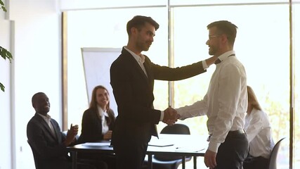 Sticker - Boss shaking hands welcoming new employee during morning briefing in modern boardroom, diverse staff on background cheers newcomer with applauses, worker of month receive praise gratitude from chief