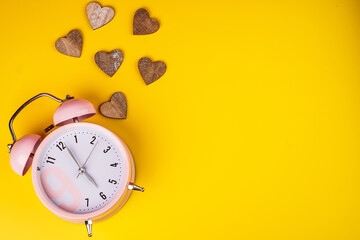 Wall Mural - Detail close up of the old pink vintage alarm clock on colour background with free copy space.