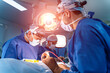 © Vadim - Medical team performing surgical operation in bright modern operating room. Medical devices for neurosurgery.