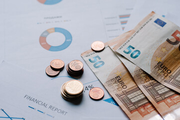 Close-Up coins in money graph financial statistics.