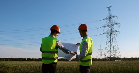 Wall Mural - engineers in special form discuss the power lines repairing plan. new power line construction plan.