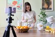 © Valerii Honcharuk - Girl teenager food blogger cooking orange pancakes at home in kitchen