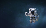 Fototapeta Kosmos - Astronaut on background with space and stars. Wallpaper for background. Elements of this image furnished by NASA
