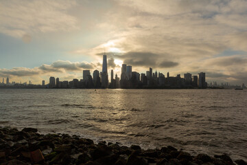 Wall Mural - New York, NY /United States - Aug. 3, 2018: Sunrise over Lower Manhattan with the Upper Harbor in the foreground.