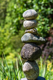 Fototapeta Desenie - Stacked rocks in a garden, meditation focus for wellness
