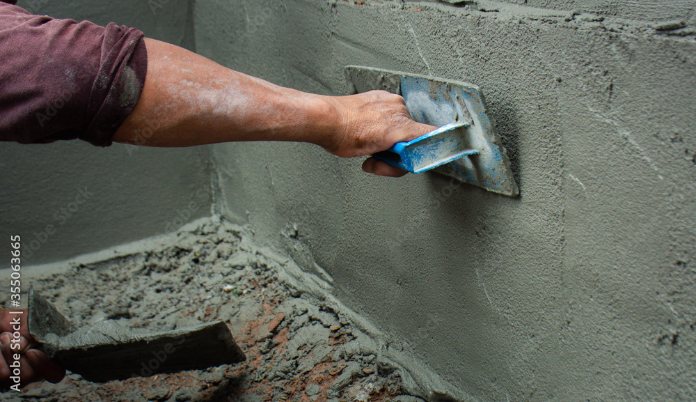Construction workers in industrial buildings are plastering to build ...