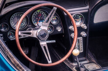 Part Of The Interior Of An Oldtimer Luxury Sports Car With Steering Wheel, Speedometer, Fuel, Clock Dials, Gear Lever, Front Panel