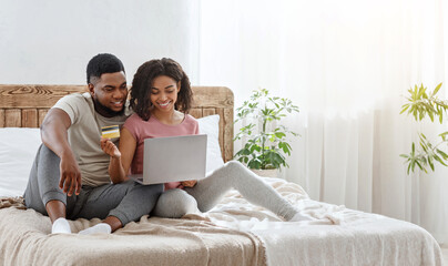 Young african couple happy to make purchases online