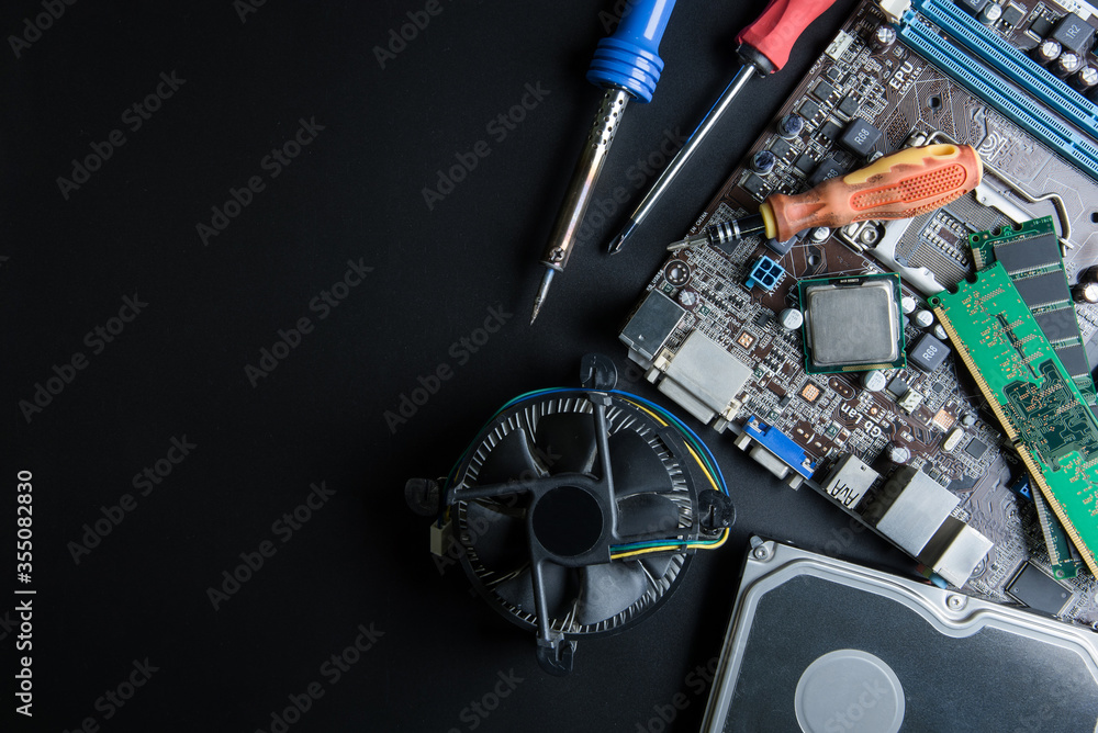 Personal computer motherboard and computer accessories equipment close up on black background with copy space for your text.Technology concept.