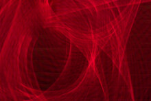 A Red Swirl Loop Of Ripples On Dark Background Looks Powerful And Confused. Long Exposure Light Painting.
