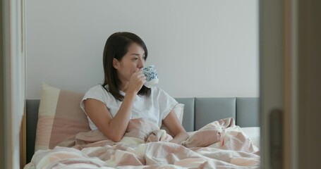 Wall Mural - Woman drink of water on bed