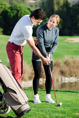 Wall Mural - Golf couch is training girl to play golf