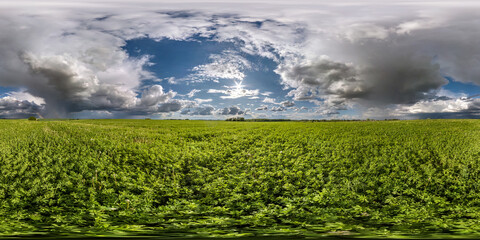 Wall Mural - full seamless spherical hdri panorama 360 degrees angle view among fields in spring day with awesome clouds before storm with rainbow in equirectangular projection, for VR AR virtual reality content