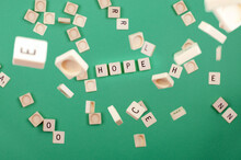 Green Background With Scrabble Pieces With The Word Hope And Pieces Falling