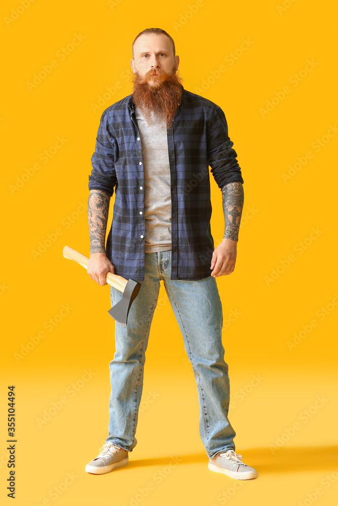 Handsome lumberjack on color background