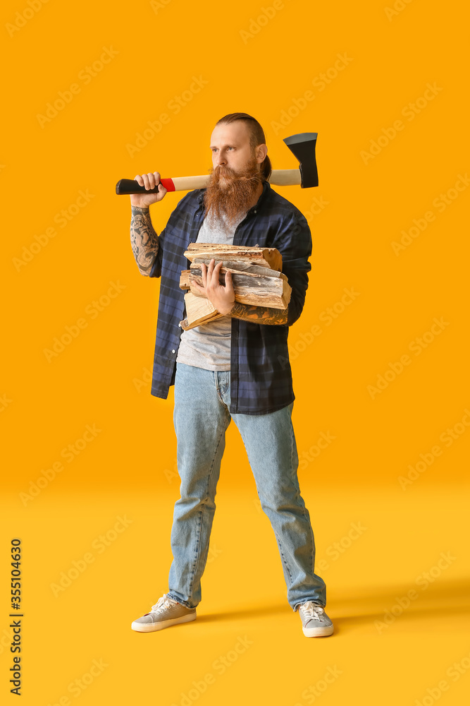 Handsome lumberjack on color background